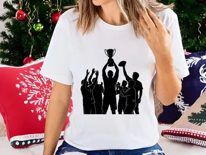 Victorious team celebrating with a trophy in silhouette