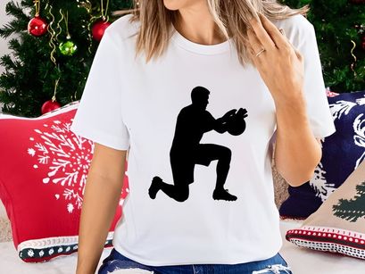 A silhouette of a man in a kneeling position throwing a ball