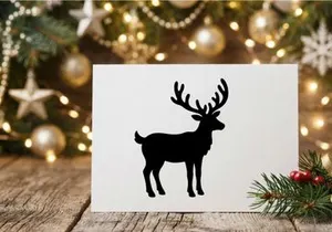 Black silhouette of a reindeer with large antlers isolated on a white background