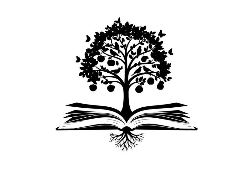 Silhouette of tree growing out of open book with birds