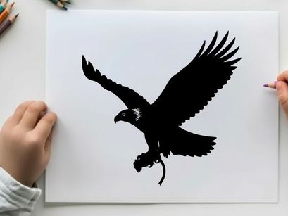 Silhouette of an eagle in flight with outstretched wings and talons