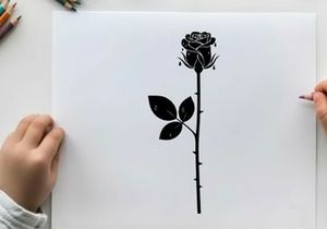 Silhouette of a single black rose on white background