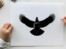 Silhouette of a bird with outstretched wings in flight