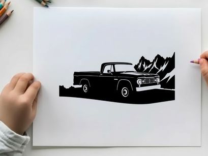 Silhouette of a vintage pickup truck in front of mountains