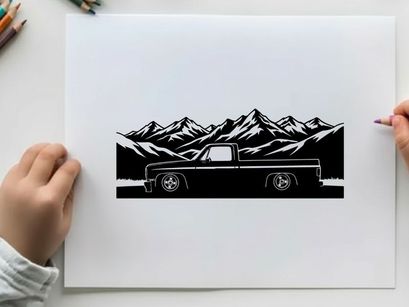 Silhouette of a pickup truck in front of majestic mountain range silhouette