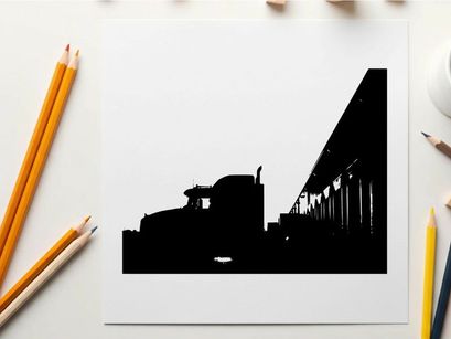 Truck silhouette parked beside a building at sunset