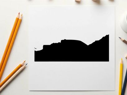 Silhouette of a pickup truck in front of a mountain range silhouette