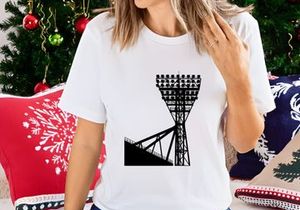 A large stadium light tower against a white sky background silhouette