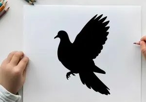 Silhouette of a bird in flight with wings spread wide