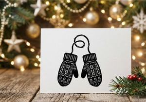 Pair of knitted winter mittens with snowflake pattern isolated on white background