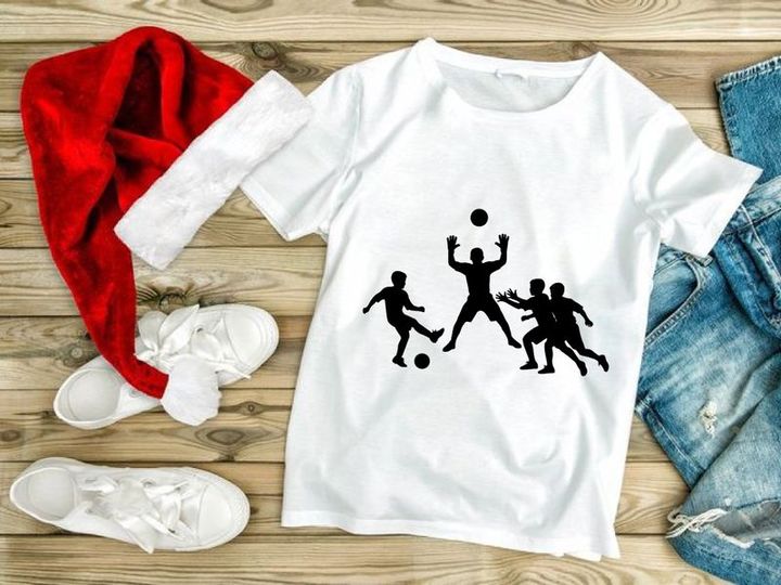 Silhouette of four men playing soccer or football with ball
