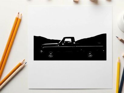 Silhouette of a classic pickup truck against a mountainous backdrop silhouette