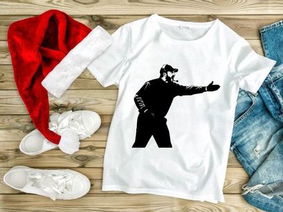 A black and white image of a sports coach gesturing on the field with a headset