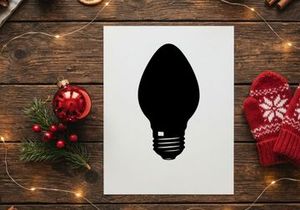 Black silhouette of a classic light bulb isolated on a white background.