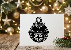 Decorative Christmas jingle bell icon with ornate filigree pattern on white background.