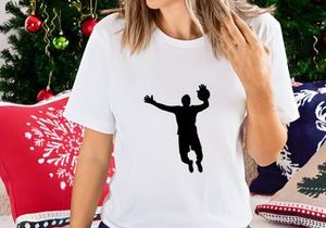 Silhouette of a man playing volleyball in mid air