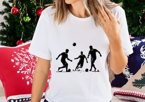 Silhouette of three soccer players in action kicking balls