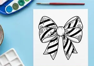 Elegant black and white striped Christmas bow with pearl center for festive gift wrapping
