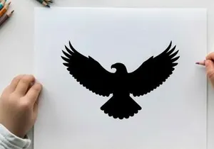 Black silhouette of an eagle in flight with wings spread wide