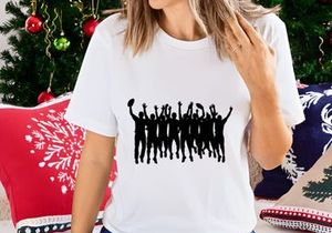 Silhouette of a group of people jumping and celebrating with frisbees in the air