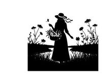 Silhouette of a woman in a field with flowers and a basket