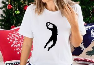 A silhouette of a person playing volleyball with a ball in mid air