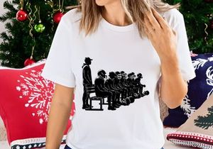 A group of people sitting in a line with one standing beside them
