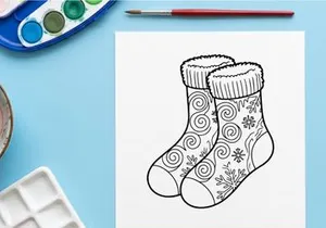 Pair of festive Christmas socks with snowflake and swirl patterns for holiday celebrations