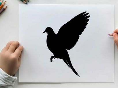 Silhouette of a bird in flight with wings spread wide