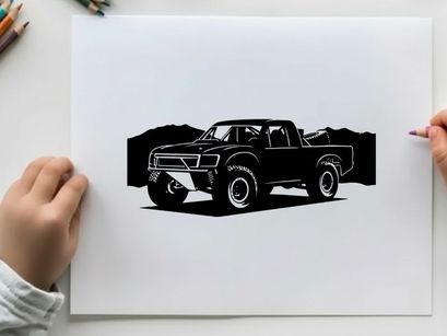 Silhouette of a pickup truck in front of mountains