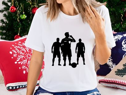 Three soccer players in black silhouette with a ball