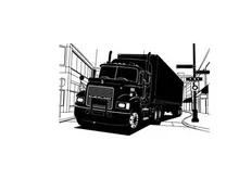 Silhouette of a semi truck driving down a city street