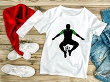 Soccer player in mid air balancing ball on foot in green and black silhouette
