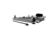 Silhouette of people working on a large industrial or construction site at night
