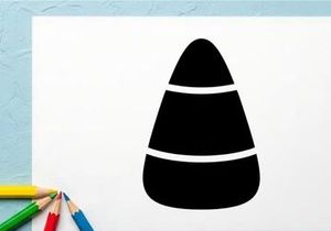 Close-up of a black and white candy corn on white background