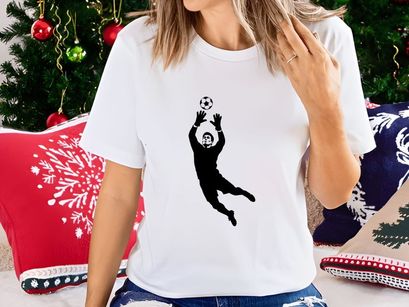 Soccer goalkeeper in action catching a ball