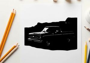 Silhouette of a classic pickup truck in front of mountains