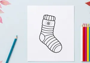 Cozy Christmas sock with snowflake pattern isolated on white background for festive holiday decor