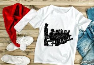 A group of people sitting in a line with one standing beside them