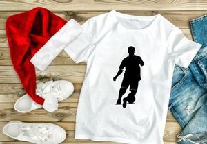 Silhouette of a soccer player kicking a ball in action