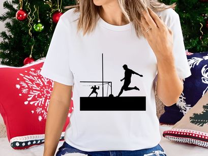 Soccer player kicking ball while goalkeeper attempts to block in a match