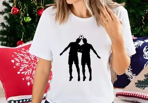 Two soccer players in silhouette heading a ball in mid air competition