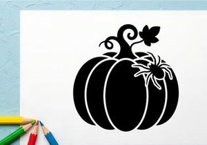 Silhouette of a pumpkin with a spider and leaf for Halloween decor