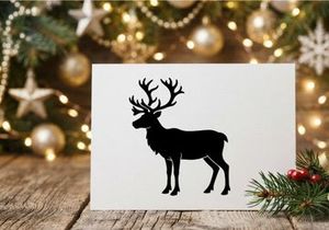Black silhouette of a reindeer with large antlers isolated on a white background.