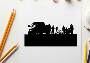 Silhouette of people gathered around campfire beside a truck