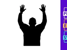 A silhouette of a man with his hands raised up in the air in celebration or triumph