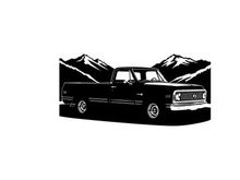 Silhouette of a classic pickup truck against mountain range silhouette