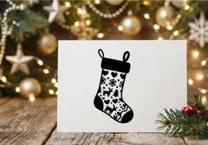 Black and white Christmas stocking icon with reindeer and snowflake pattern design