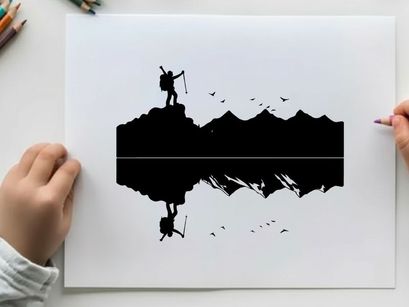 Silhouette of a hiker on a mountain peak at sunrise