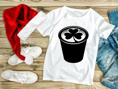 Black coffee cup with white shamrock foam design isolated